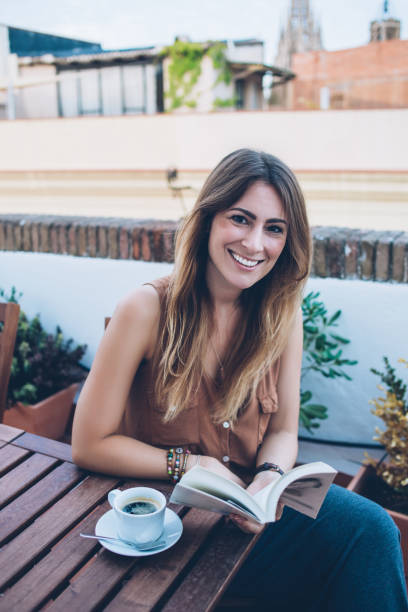 istock Relaxed woman with book in cafe 1449441116