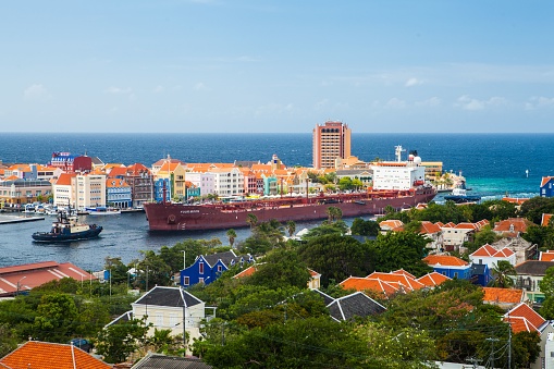 Willemstad, Curacao – September 14, 2022: A Containership entering the St Anna bay harbor in Curacao