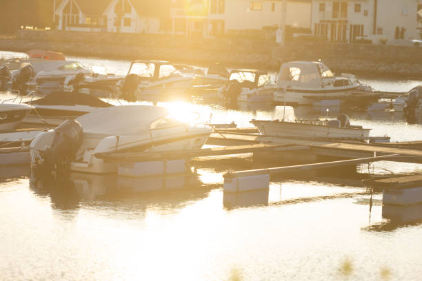 Lindesnes, Norway - August 08 2022: Powerboats in a marina in sharp sunset light