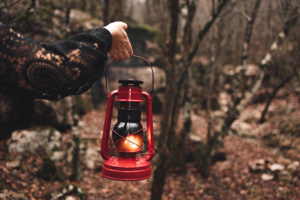 istock A red kerosene lantern in the autumn forest. Old kerosene lamp. 1449449694