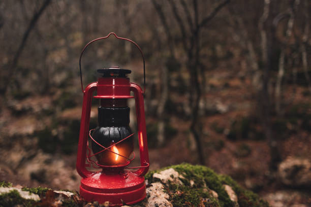 istock A red kerosene lantern in the autumn forest. Old kerosene lamp. 1449449704