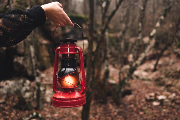 istock A red kerosene lantern in the autumn forest. Old kerosene lamp. 1449449709