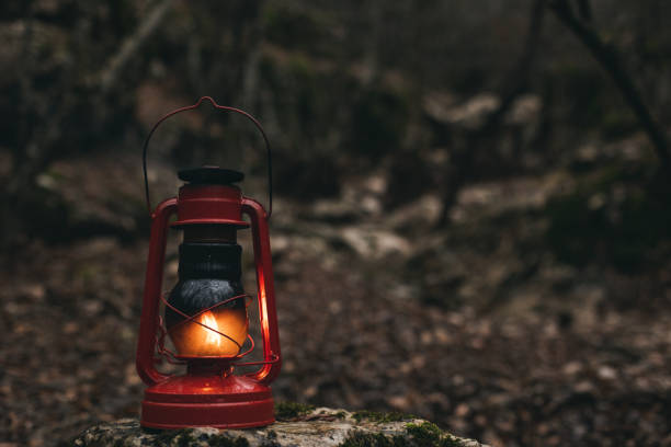istock A red kerosene lantern in the autumn forest. Old kerosene lamp. 1449449720