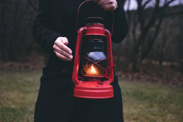 istock A red kerosene lantern in the autumn forest. Old kerosene lamp. 1449449775
