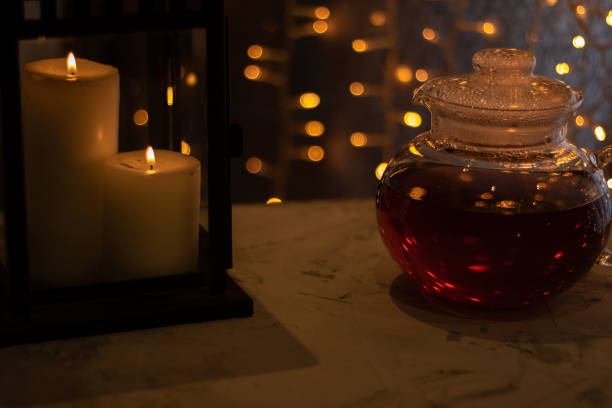istock photo glass kettle with tea next to candles 1449456180