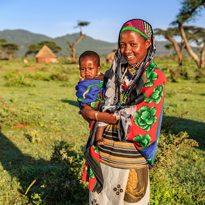 Woman from Borana tribe holding her baby, southern Ethiopia, Africa. The Borana Oromo are a pastoralist tribe living in southern Ethiopia and northern Kenya.