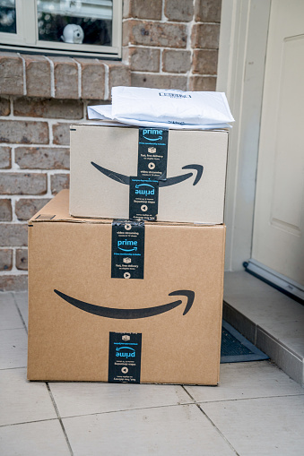 Sydney, Australia - 2022-07-22 Amazon prime boxes and envelopes delivered to a front door of residential building. Black Friday Cyber Monday Christmas Sale Prime Day. Amazon Flex delivery