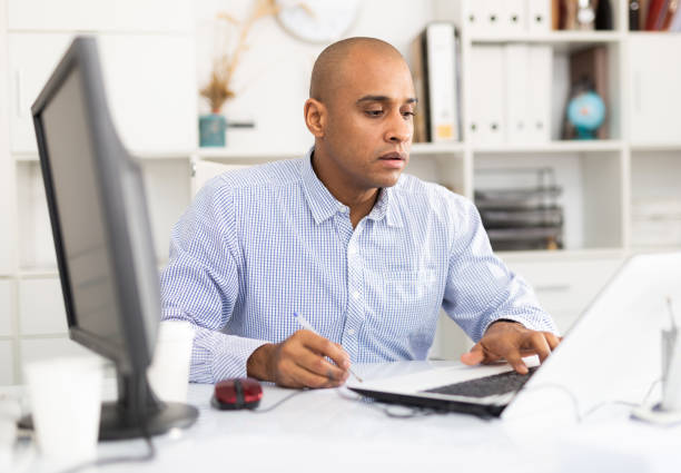 istock Successful businessman working with papers and laptop 1449458359