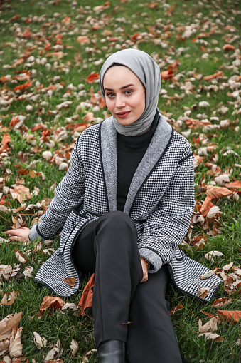 Beautiful woman wearing hijab in autumn