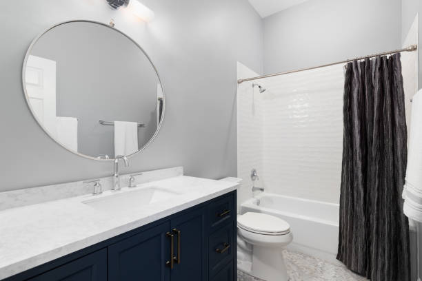 istock A bathroom with a blue cabinet and subway tile shower. 1449461394
