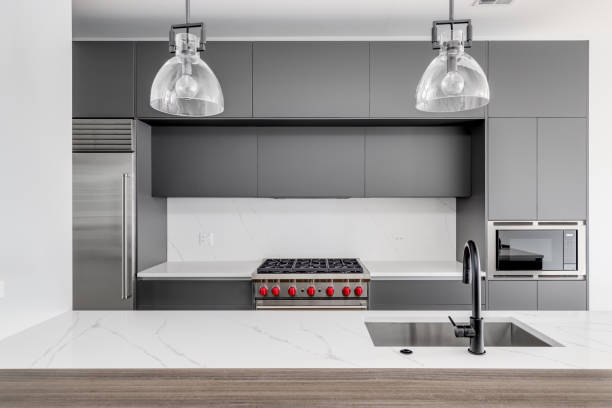 istock A modern kitchen detail with grey cabinets and a white marble countertop. 1449461511