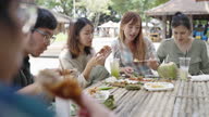 istock Group of Asian people talking and sharing Thai traditional foods in street market 1449461546