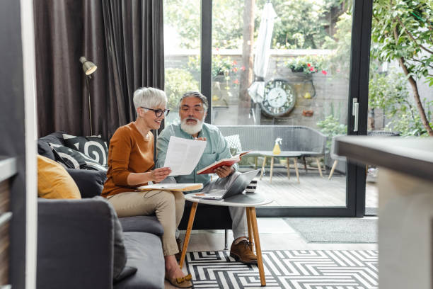 istock Senior couple discussing home finances and using laptop 1449466247