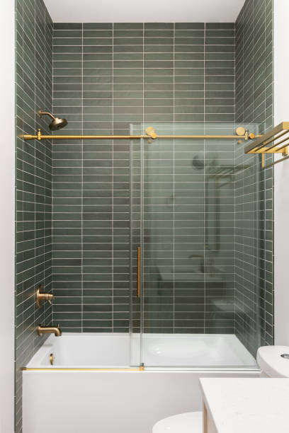 istock A shower with green subway tiles. 1449471360