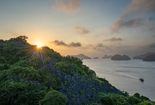 Vibrant Sunset Over the Tropical Paradise of Cat Ba Island, Vietnam in Lan Ha & Ha Long Bay in Southeast Asia Vibrant sunset over the tropical paradise of Cat Ba Island, Vietnam in Lan Ha & Ha Long Bay, southeast Asia. haiphong province photos stock pictures, royalty-free photos & images