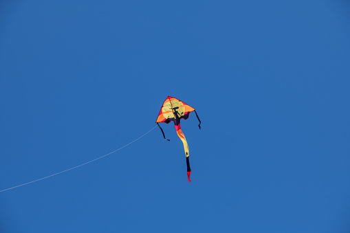 a nice colourful kite high in the sky