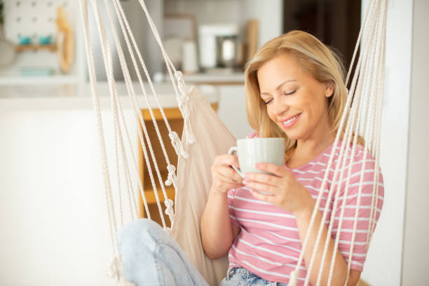 istock Woman having coffee and relaxing at home 1449475189