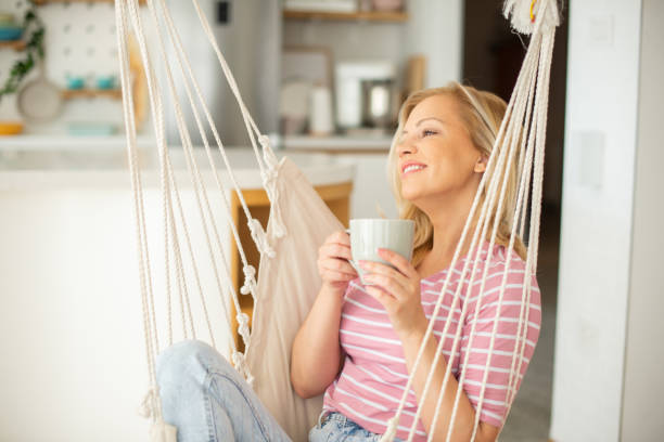 istock Beautiful woman relaxing and drinking hot tea 1449475199