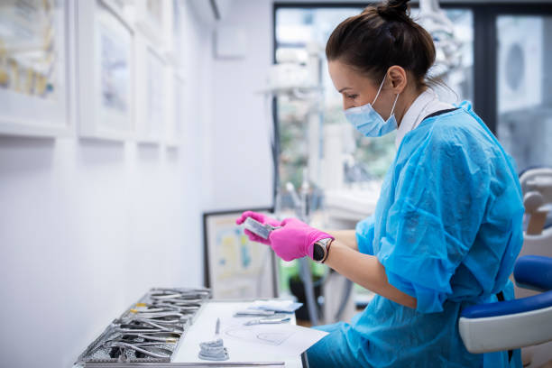 istock Orthodontist examining dentures in her office. 1449475989