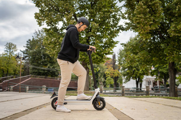 istock caucasian man drive or ride electric kick scooter e-scooter 1449476437
