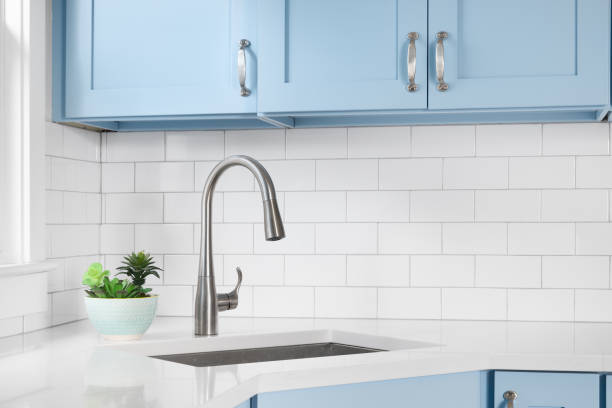 istock A blue kitchen with a silver faucet and subway tile backsplash. 1449479375