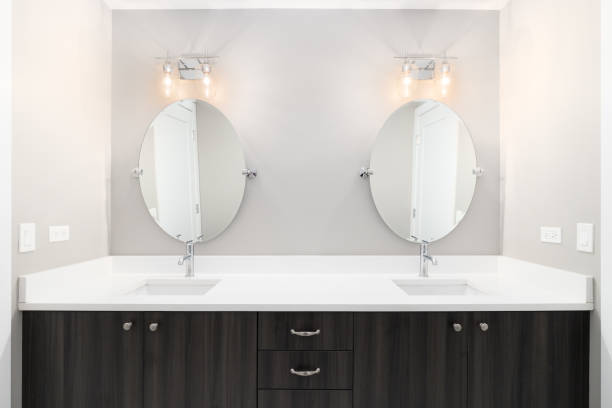 istock A bathroom with a wood vanity and marble countertop. 1449479391