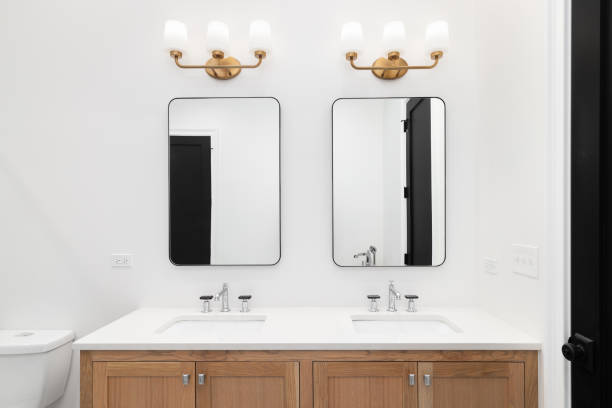 istock A bathroom with gold lights and a wood vanity. 1449479395
