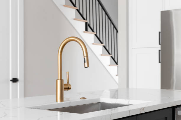 istock A gold kitchen sink detail shot in a white kitchen. 1449481239