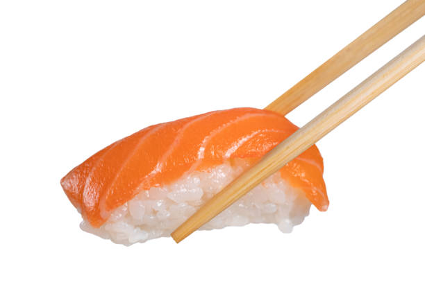 istock chopsticks holding a piece of nigiri 1449482450