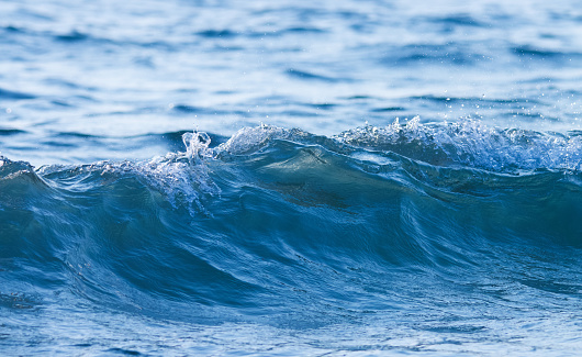 Blue ocean wave splashing on the beach. Sea wave.