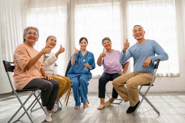 istock Asian elderly group listening to the treatment method with the doctor during Self help therapy meeting 1449496273