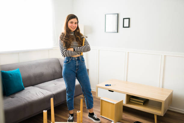 istock Cheerful woman using tools to assembly furniture 1449498503