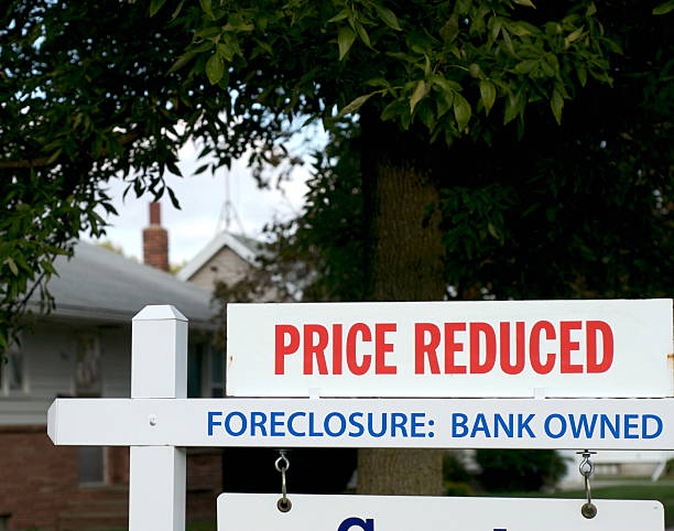Real Estate Down Market: Foreclosure Real estate sign reflecting the drastic rise in foreclosures in the residential home market industry. foreclosure photos stock pictures, royalty-free photos & images