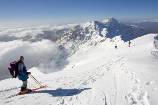 alpine skiers en la cima de una montaña photo