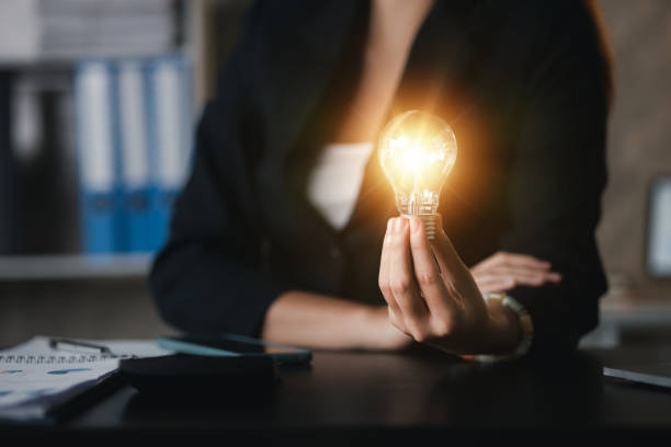 istock Person hold glowing light bulb, Creative new idea. Innovation, brainstorming, strategizing to make the business grow and be profitable. Concept execution, strategy planning and profit management 1449514325