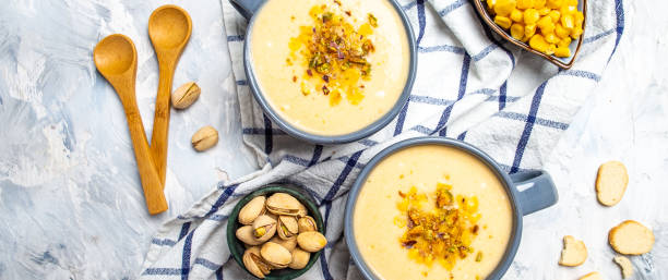 istock Corn Soup, Vegan cuisine. Traditional autumn corn soup. Served with corn cobs, roasted pistachios and croutons, Restaurant menu, dieting, cookbook recipe, top view 1449520113