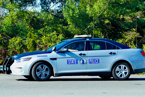 Fairfax, Virginia, USA - November 17, 2022: A Virginia State Police Trooper waits to turn at an intersection in the City of Fairfax on a sunny day.