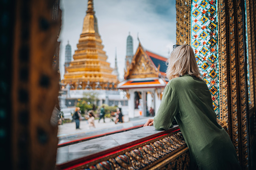 Young woman exploring Grand Palace and Wat Phra Kaew in Bangkok, Thailand