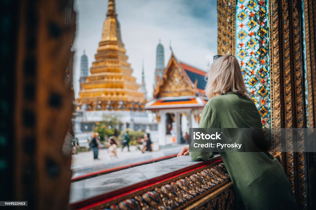 Young Woman Exploring The Grand Palace in Bangkok Young woman exploring Grand Palace and Wat Phra Kaew in Bangkok, Thailand Thailand Stock Photo
