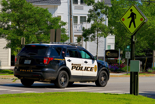 Brunswick, Maine, USA - July 1, 2019: A Brunswick Police vehicle patrols the streets of the town near Bowdoin College.