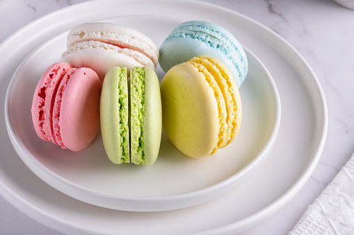 French macaroons on white plate.