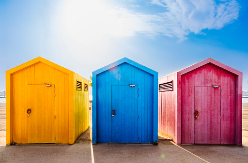 beach huts colorful yellow, blue, and pink
