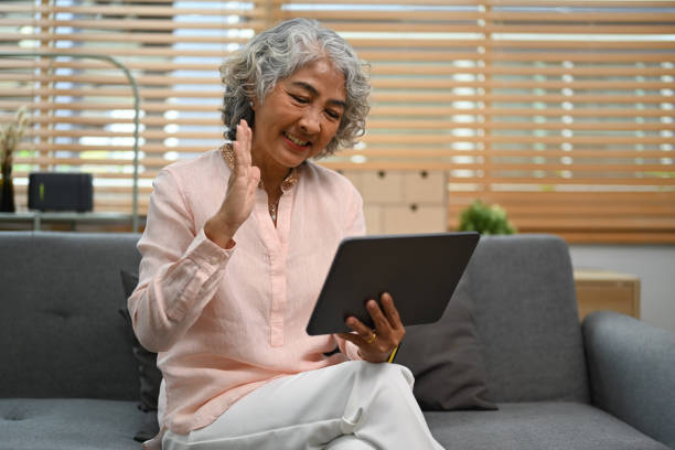 istock Pleasant middle age woman checking social media, making video call on digital tablet. 1449528267