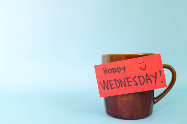 istock Welcome, hello and happy Wednesday concept. Selective focus of coffee cup with written message isolated in blue background. 1449529073