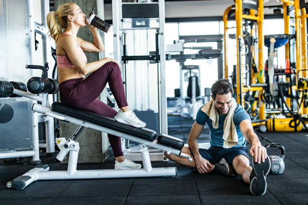 istock Young athletic couple resting on a break in a gym. 1449529964