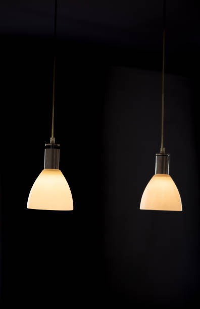 istock Two hanging lamps over a dark background 1449530813