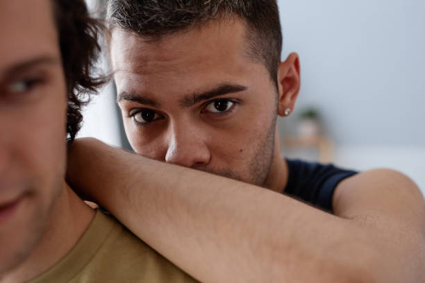 istock Young man embracing boyfriend close up 1449531475