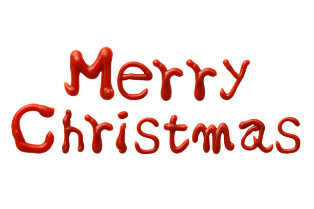 Close-up of Merry Christmas written with ketchup on white background.