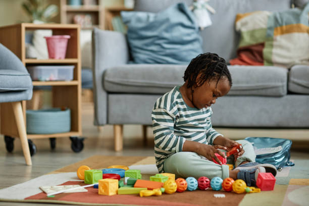 istock Cute black baby playing with toys 1449533383