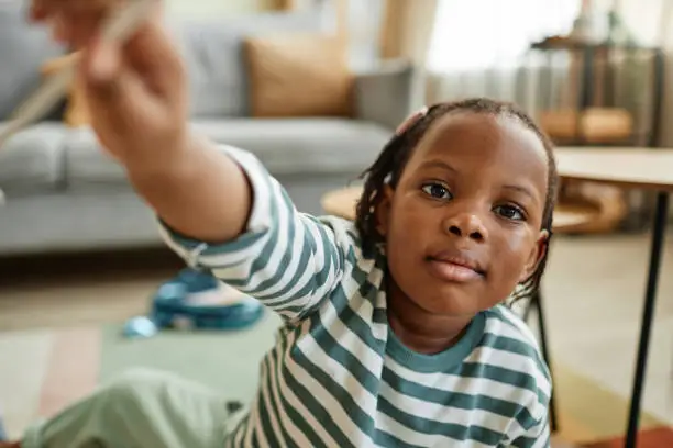 Photo of Cute black baby reaching for camera